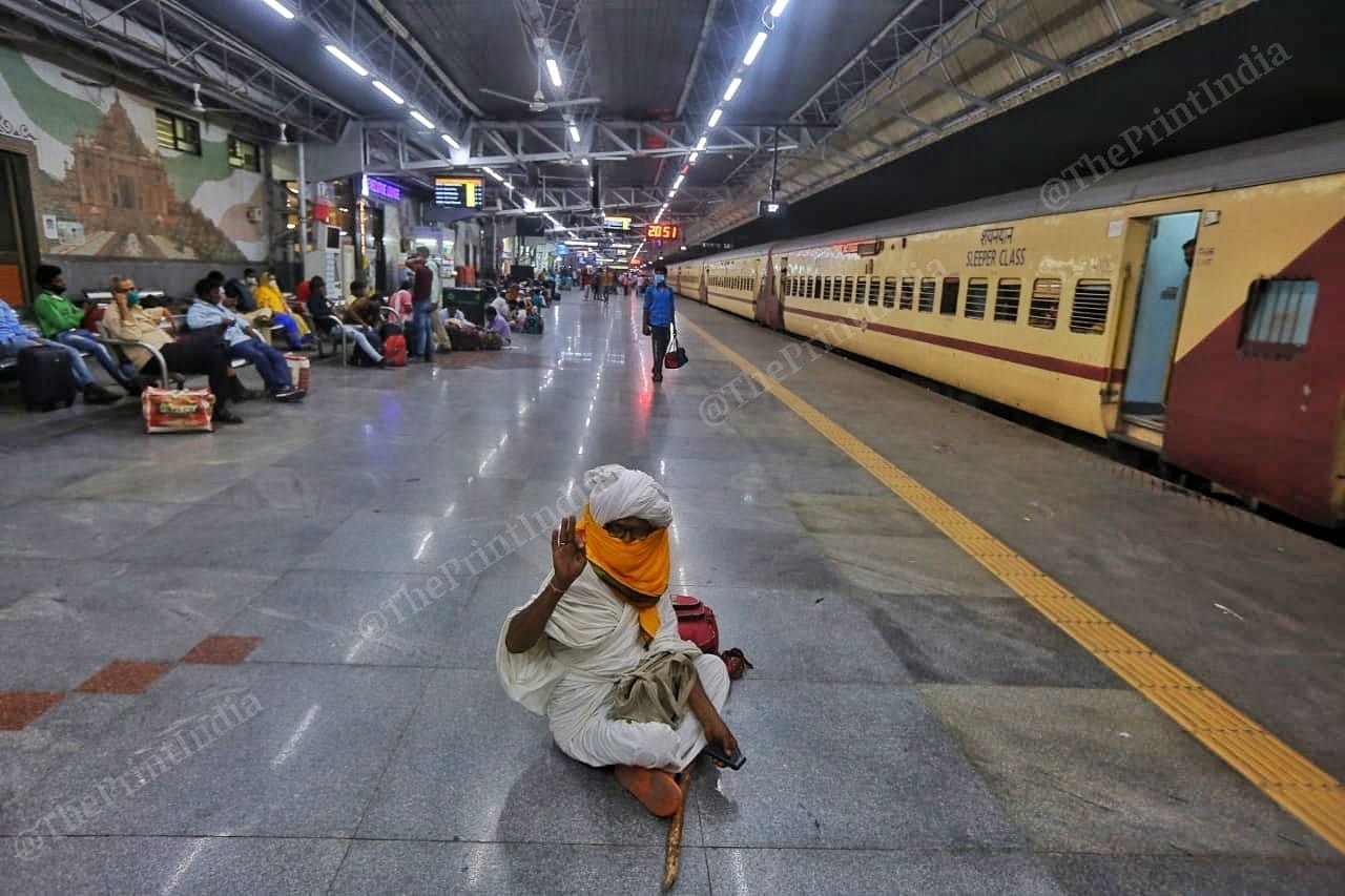 A passenger waits at the platform in the night | Photo: Praveen Jain | ThePrint