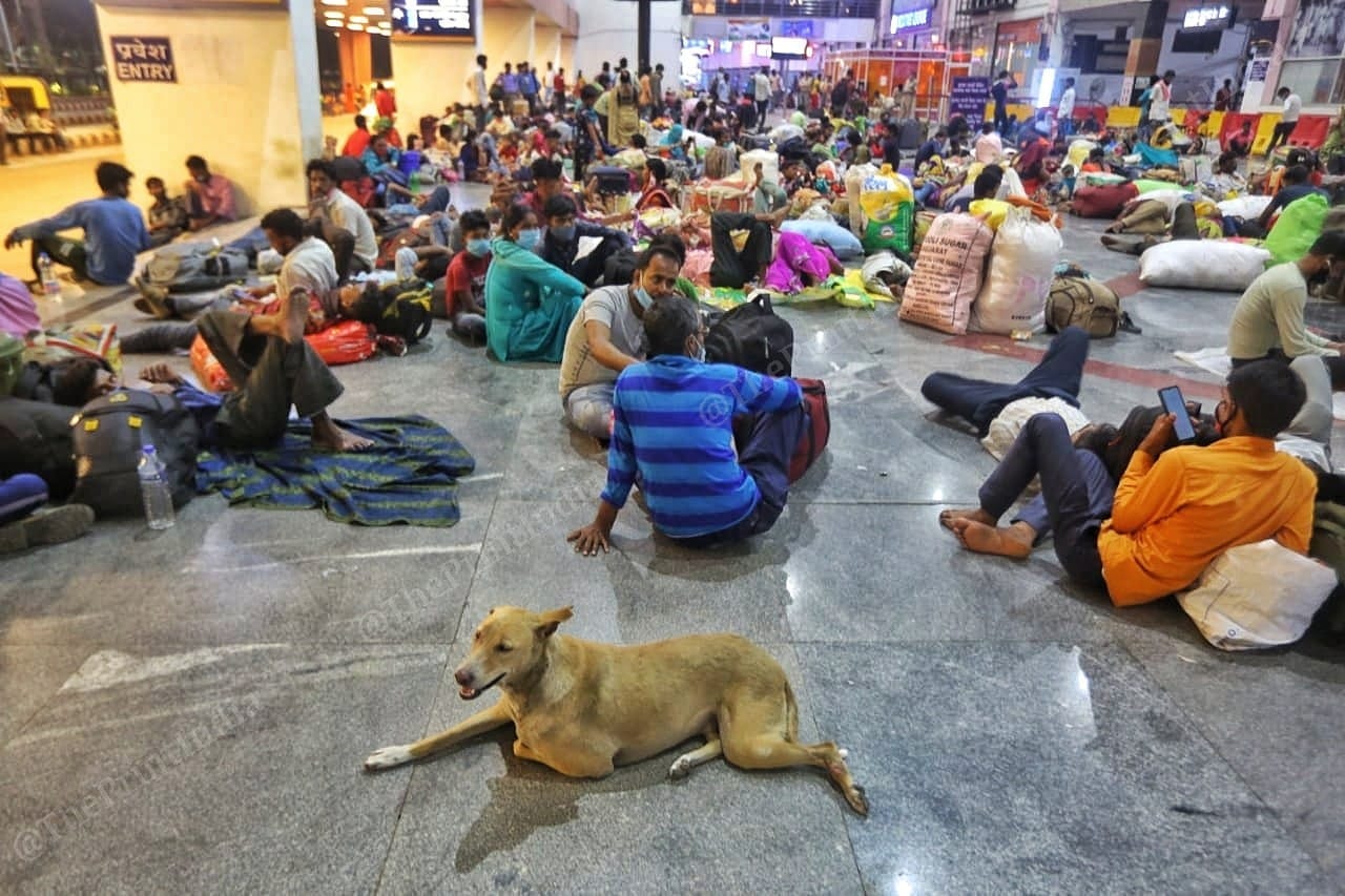 Mirgants workers sits in platform to wait for their trains | Photo: Praveen Jain | ThePrint