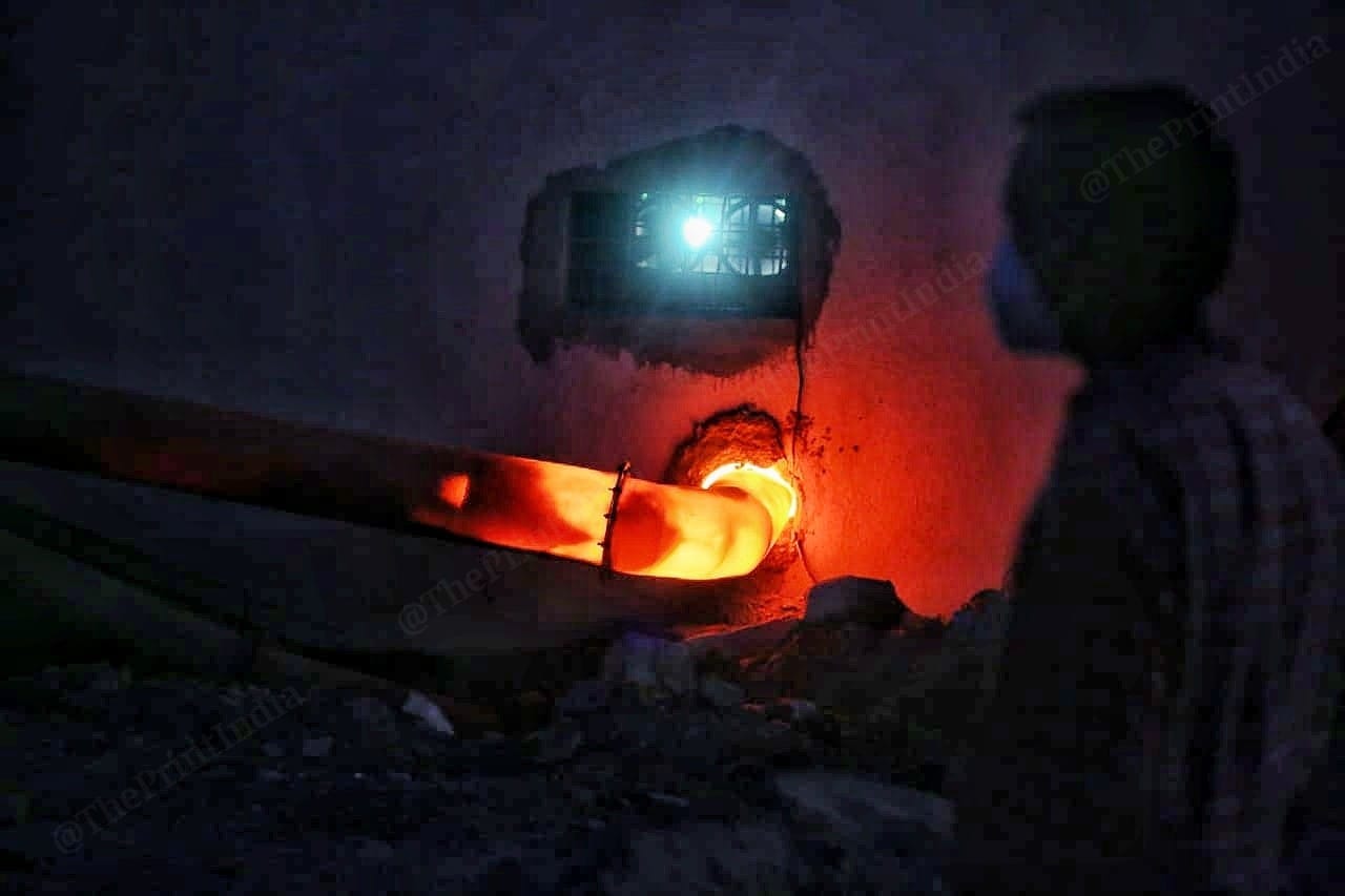 A man waits as a body gets cremated | Photo: Praveen Jain | ThePrint