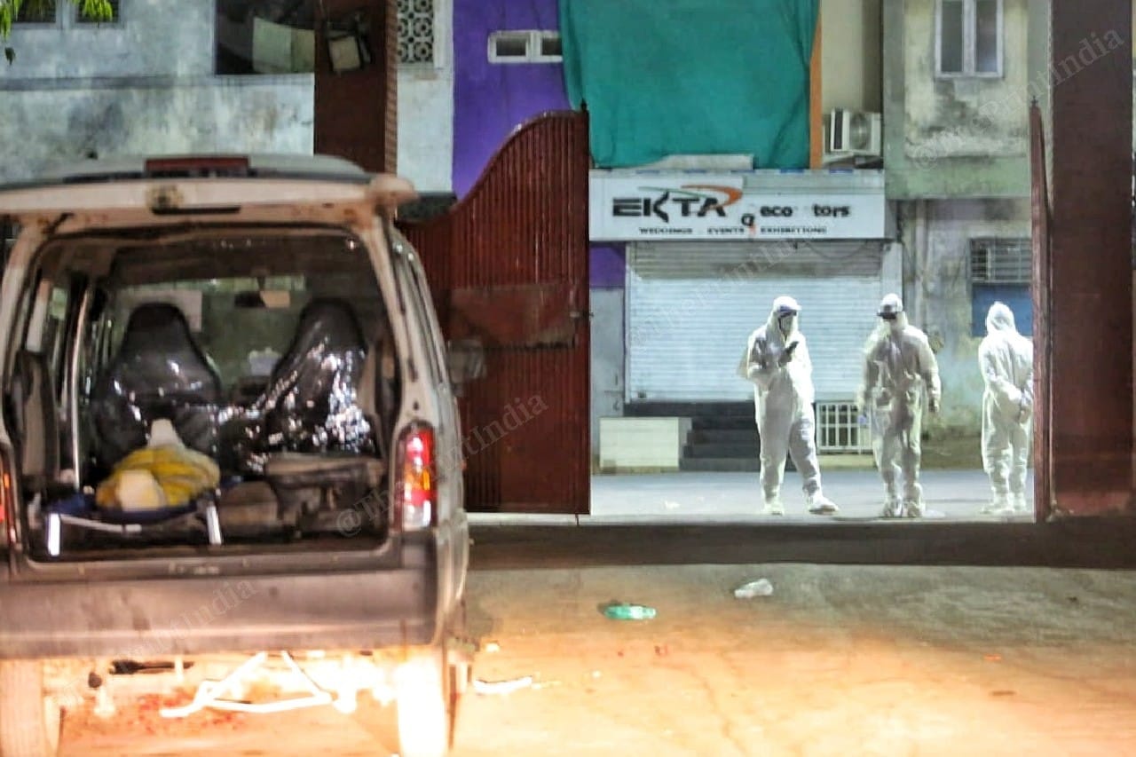 A group of PPE clad crematorium workers at Ellisbridge crematorium at night | Photo: Praveen Jain | ThePrint