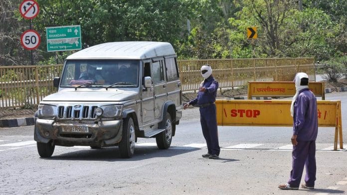 Health department personnel motion to a car on the Chhattisgarh side of the Bagnadigaon border between Rajnandgaon district and Maharashtra | Photo: Suraj Singh Bisht | ThePrint