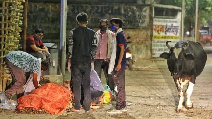 Even after death, life goes on. A body lays by the side of the road in wait | Photo: Praveen Jain | ThePrint