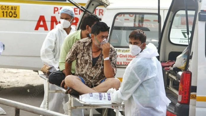 A Covid patient is offered medical support outside the New Civil Hospital of Surat | Soniya Agrawal | ThePrint