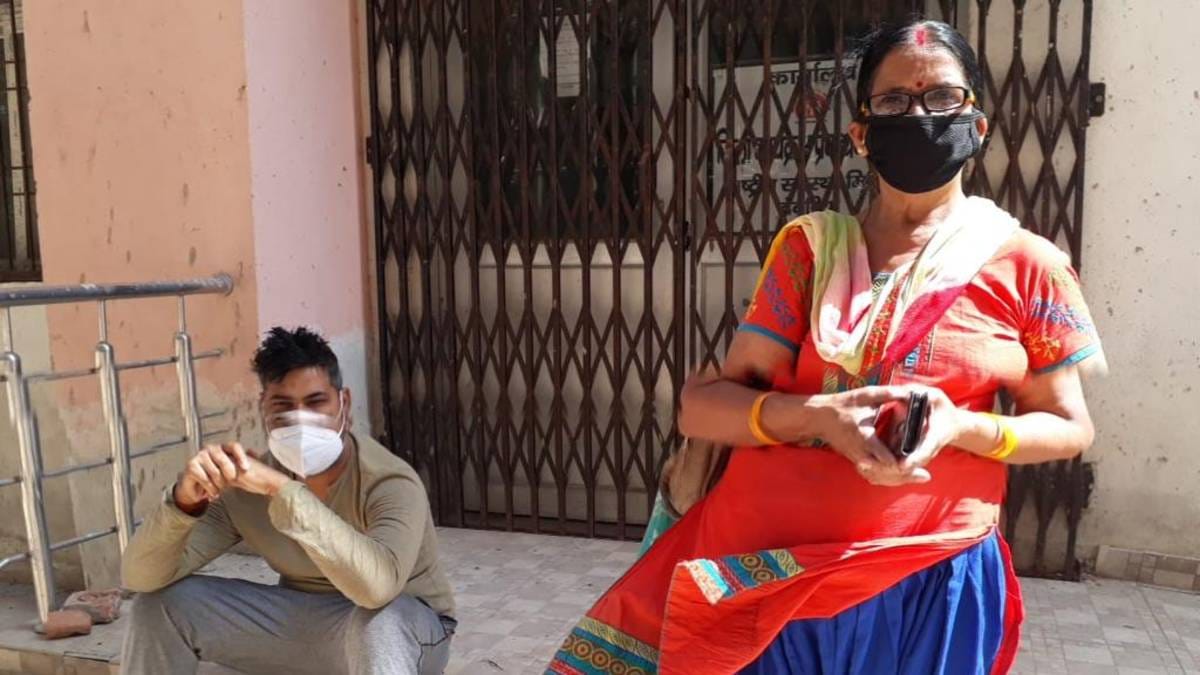 Retired school teacher Nirmala Tripathi, with her son Vivek, a Covid patient, outside the Covid treatment facility at Deoria district hospital | Moushumi Das Gupta | ThePrint