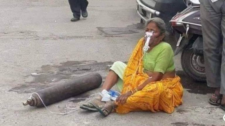 Viral photo of woman on road with oxygen cylinder not recent, is from 2018