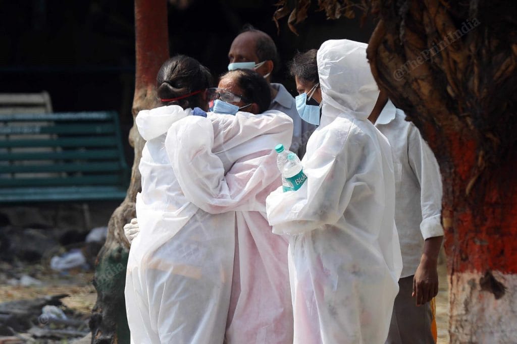 A common visual outside mortuary, hospitals and crematoriums. Family members holding each other, trying to cope with the pain | Suraj Singh Bisht | ThePrint
