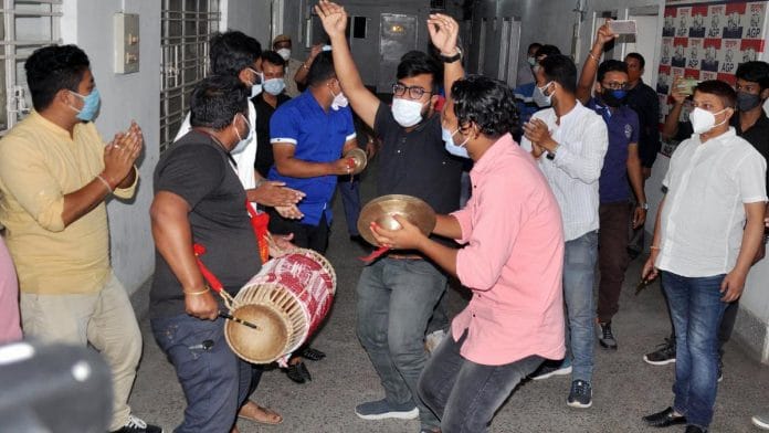 Members of BJP's Assam ally Asom Gana Parishad celebrate their victory at the party head office in Guwahati Sunday | ANI