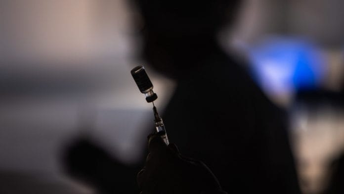 A healthcare worker prepares a dose of the Oxford-Astrazeneca Plc. Covid-19 vaccine | Photographer: Jonne Roriz | Bloomberg