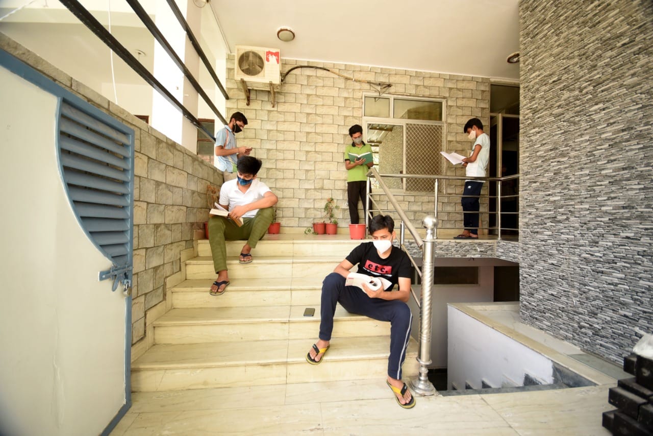 A group of friends seen doing group studies while following Covid-appropriate behaviour in their hostel. | Photo: Rohit Jain Paras/ThePrint