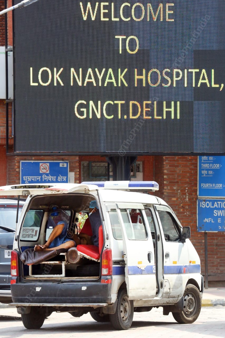 A patient lies in an ambulance van outside LNJP hospital | Praveen Jain | ThePrint.