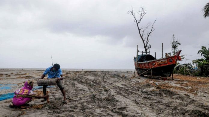 Villagers try to save their boat at Fraserganj, ahead of the landfall of cyclone Yaas, in South 24 Parganas district, on 25 May 2021 | PTI