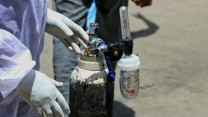 A healthcare worker handling an oxygen cylinder | Representational image | Photo: ThePrint