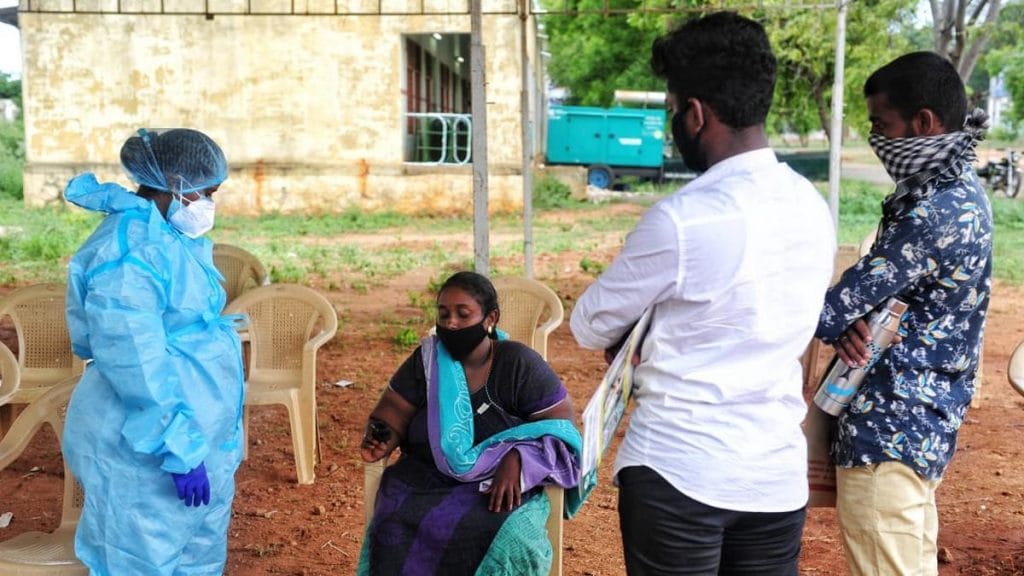A member of the nursing staff checks the oxygen levels of a patient at the Tirunelveli Medical College | Photo: Suraj Singh Bisht | ThePrint