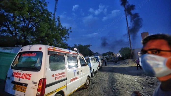 Ambulances queue up outside outside the Juna vadaj crematorium as chimneys bellow smoke | Photo: Praveen Jain | ThePrint