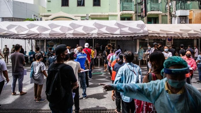 Healthcare workers direct people through waiting for lines at a temporary Covid-19 testing site in Bangkok, Thailand, on 19 April, 2021 | Photographer: Andre Malerba | Bloomberg