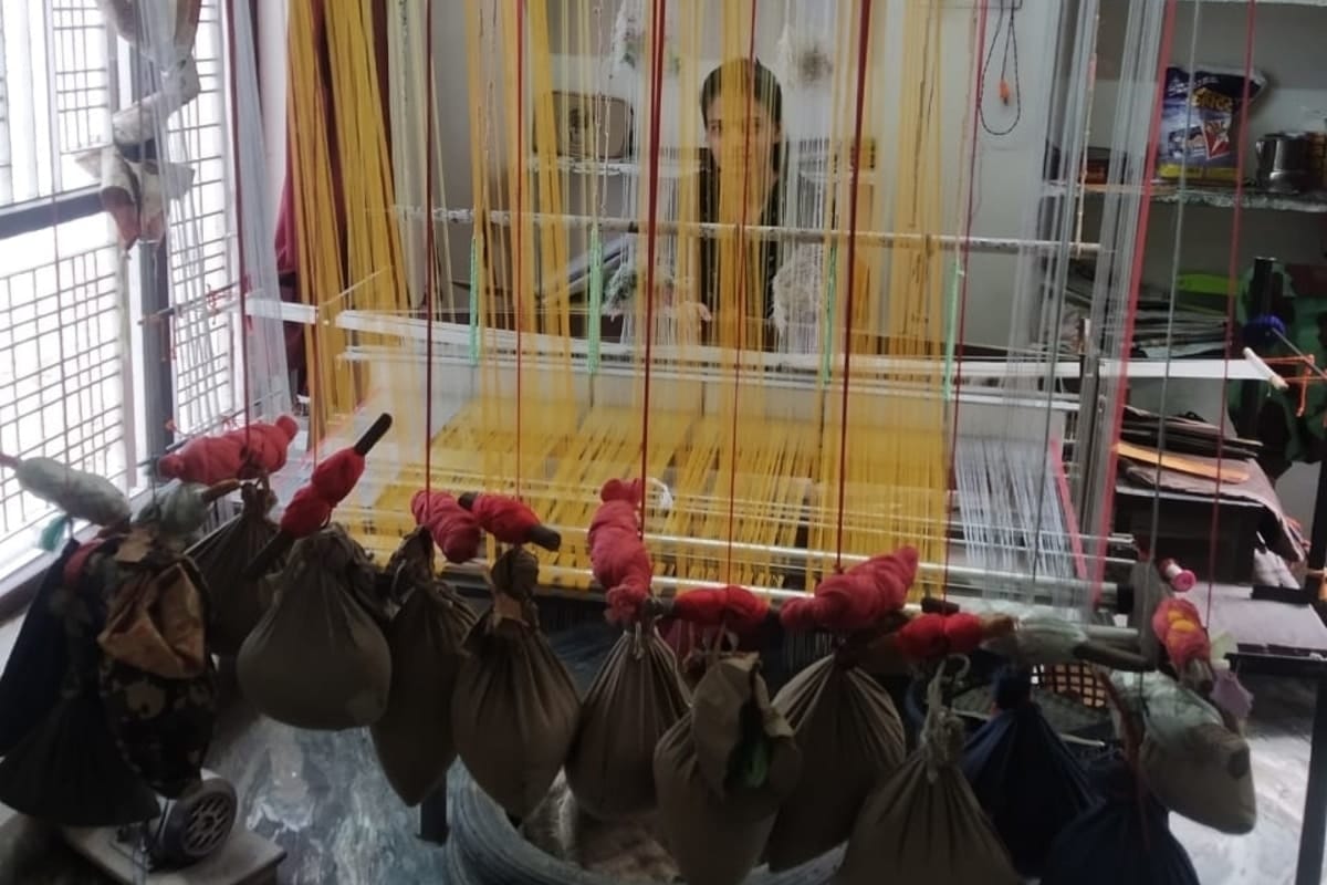 A weaver seen at Shabbir Hussain’s shop amid the lockdown under which the Rajasthan government has allowed production in factories. | Photo by special arrangement
