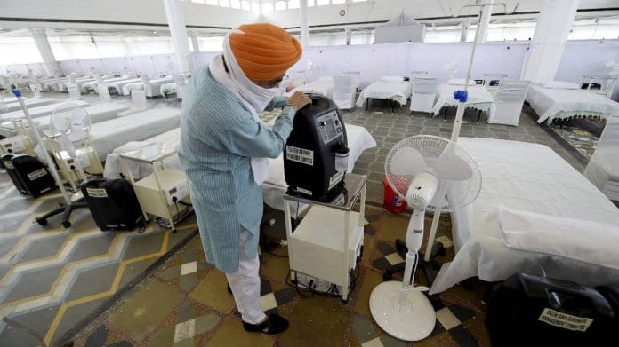 A volunteer shows an oxygen concentrator machine at Guru Tegh Bahadur Covid Care Centre at the Gurdwara Rakab Ganj Sahib in New Delhi, on 10 May 2021 | PTI