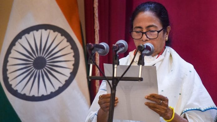 TMC supremo Mamata Banerjee takes oath as the CM of West Bengal for the third time consecutively during her swearing-in-Ceremony at Governor House in Kolkata, on 5 May 2021 | PTI