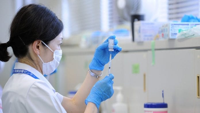 A medical worker fills a syringe with a dose of the Moderna Inc. Covid-19 vaccine at a mass vaccination site in Tokyo on 9 June, 2021 | Representational image | David Mareuil | Anadolu Agency via Bloomberg