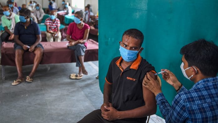 A beneficiary receives Covid vaccine dose during a vaccination drive for the homeless in New Delhi on 25 June 2021 | PTI