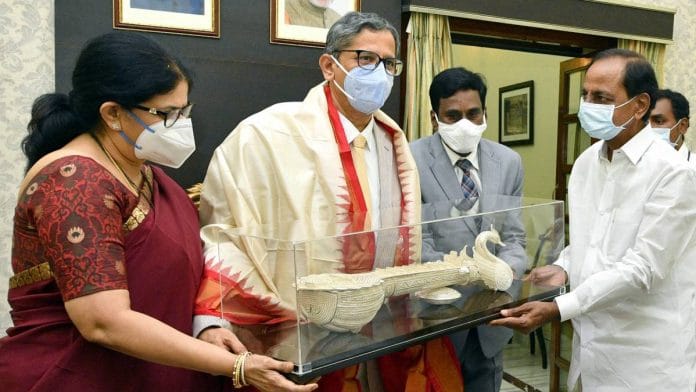 Supreme Court Chief Justice N. V. Ramana (second from left) accepts a memento from Telangana Chief Minister K Chandrashekhar Rao (right), in Hyderabad on 11 June 2021 | ANI