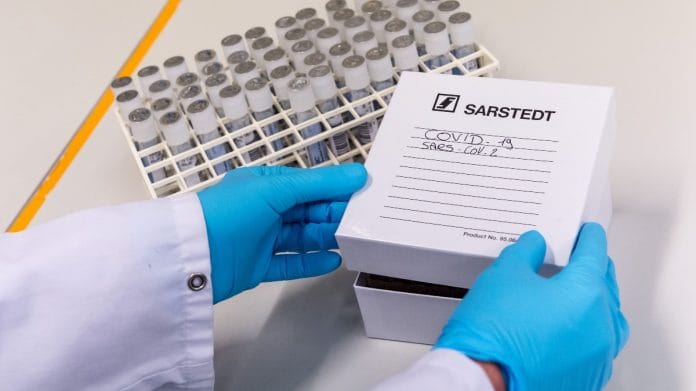 A laboratory worker boxes up test tubes of patient samples during Covid detection tests in the virology research labs at UZ Leuven university hospital in Leuven, Belgium | Photographer: Geert Vanden Wijngaert | Bloomberg
