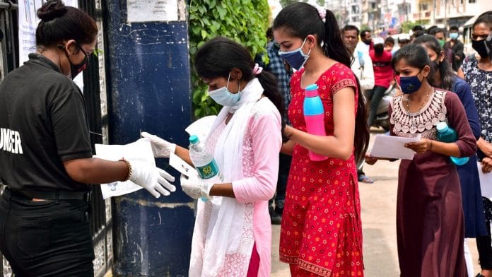 Students getting their documents verified outside an exam centre as they arrive to appear for the NEET exam, in Jabalpur on 13 September 2020 | ANI
