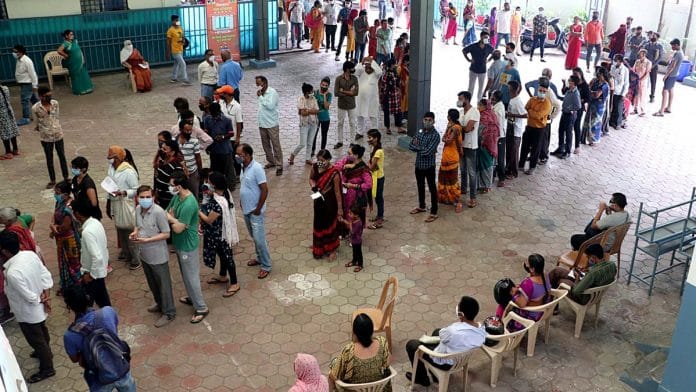 Beneficiaries wait in a queue to receive a dose of the Covid vaccine at a vaccination centre, in Bhopal on 10 July 2021 | Photo: ANI