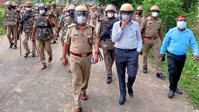 Police personnel on patrol in Chandrauli, UP, after BJP and SP workers clashed during voting for block panchayat polls Saturday | ANI
