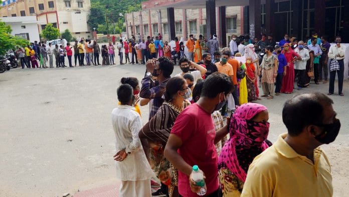 Beneficiaries wait in a queue to receive a dose of Covid vaccine at a vaccination center in Ajmer | ANI