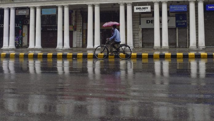 A cyclist during a mild shower at Connaught Place area in New Delhi, on 19 May 2021 | Photo: Vijay Verma | PTI