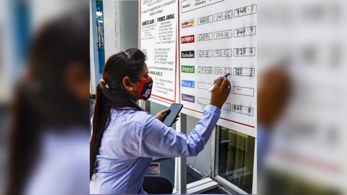 File photo of a pump attendant writing the prices at a fuel station in New Delhi | PTI