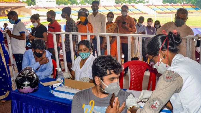 A health worker administers a dose of Covid-19 vaccine to a beneficiary, at a vaccination centre in Ranchi on 21 July 2021 |PTI