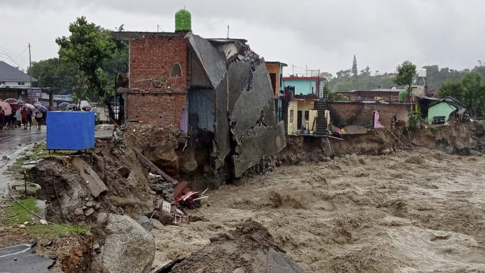 A partially washed away house amid flood water as heavy rain lash after a cloudburst in Dharamshala on 12 July 2021| Photo: PTI
