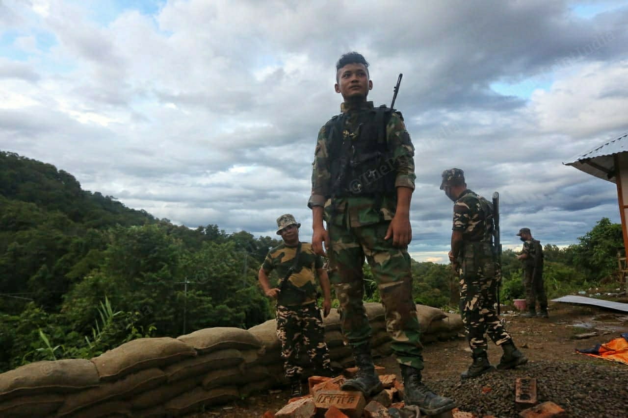 Mizoram police watching from the top of a hill that is situated on the National Highway 306. The highway connects the two states | Photo: Praveen Jain | ThePrint