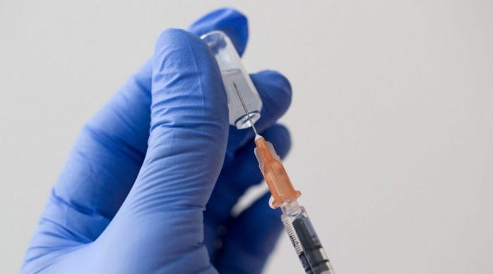 Representative Image | A health worker draws out a vaccine dose from a vial | Bloomberg