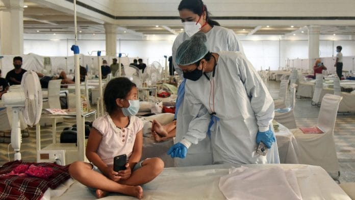 Health worker in PPE kit interacts with a Covid patient at Guru Tegh Bahadur Covid care centre at Gurdwara Rakab Ganj Sahib in New Delhi | Representational image | ANI