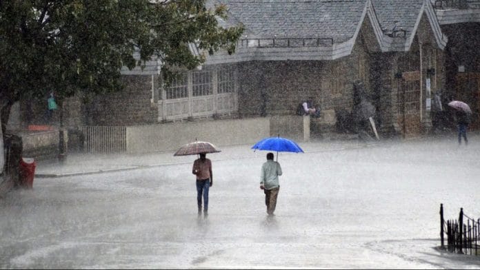 People hold umbrellas to protect themselves during heavy rain | Representational Image| ANI