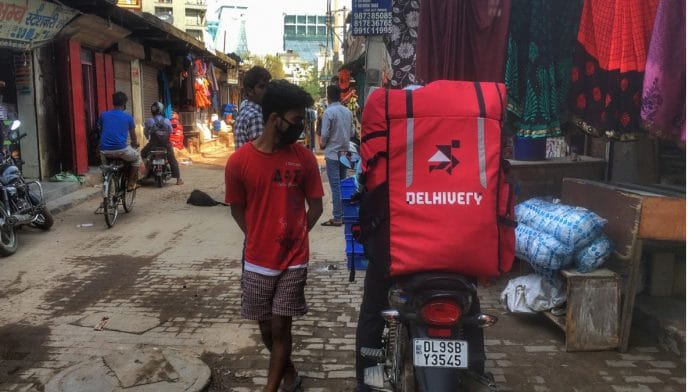 A delhivery boy waits with the orders in Gurugram on the outskirts of New Delhi, India. Photographer: Getty Images/NurPhoto via Bloomberg