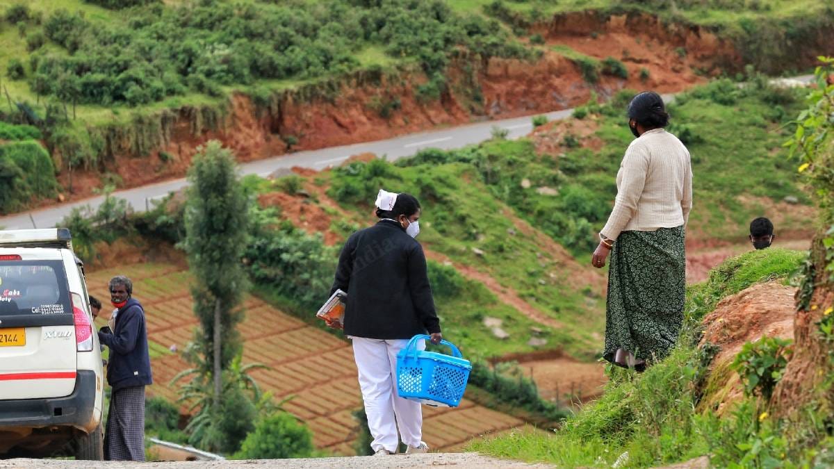 Vaccinators walk down a steep hill while out on a vaccine drive in Nilgiris district | Manisha Mondal | ThePrint