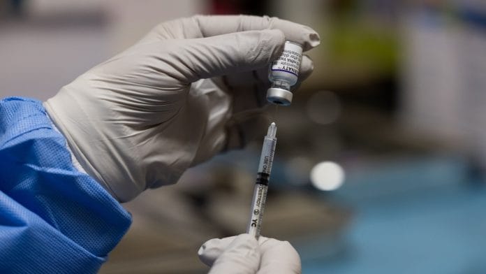 A nurse fills a syringe with a dose of the Pfizer-BioNTech Covid-19 vaccine at the Love Hospital in Seoul, South Korea, on 26 August 2021 | Photographer: SeongJoon Cho | Bloomberg