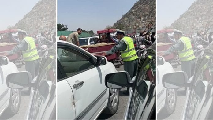 An Afghan policeman stops vehicles on a road in Kabul Sunday, asks occupants to proceed on foot | Nayanima Basu | ThePrint