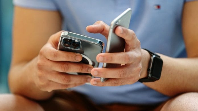 A customer tries out an Apple Inc. iPhone 12 Pro Max at the Apple flagship store during a product launch event in Sydney, Australia | Photographer: Brendon Thorne | Bloomberg