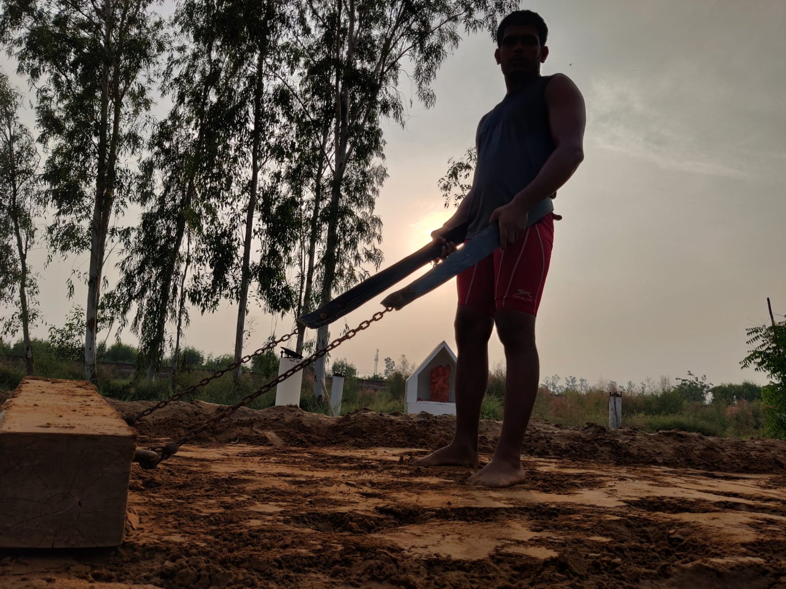 A student working on a mud pit meant for traditional wrestling. | Photo: Shubhangi Misra/ThePrint