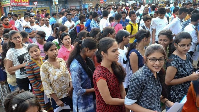 Applicants wait outside an examination centre to appear for NEET | Representational Image | PTI
