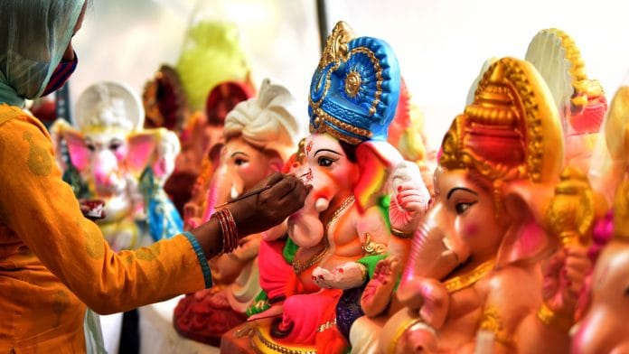 An artist gives final touches to the Idols of Lord Ganesha ahead of the Ganesh Chaturthi festival, in New Delhi on 6 September 2021 | ANI