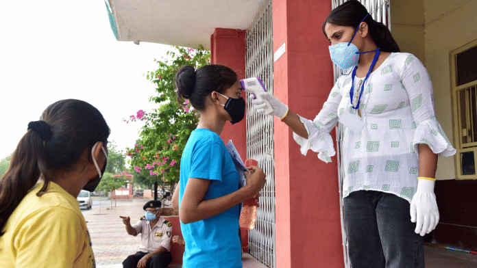 Students undergo a thermal screening process outside an exam centre as they arrive to appear for the NEET exam in Rajasthan's Bikaner on 12 September 2021 | Representational image | ANI