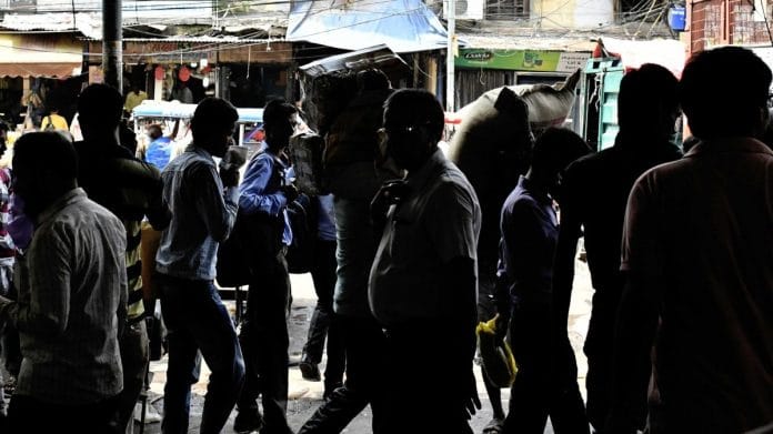 Pedestrians walk past stores at a wholesale market in the Old Delhi area | Representational image | Bloomberg