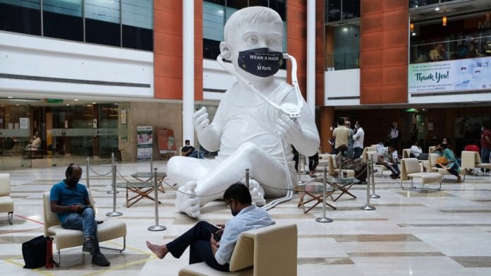A protective mask adorns the sculpture of a baby with a stethoscope in the lobby at the Fortis Memorial Research Institute hospital in Gurgaon | Photographer: T. Narayan | Bloomberg