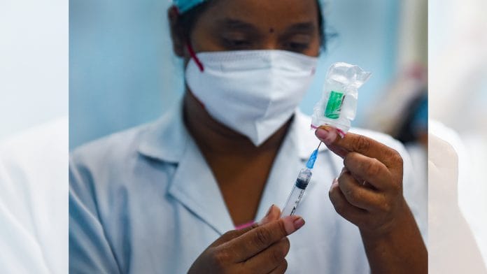 A medic prepares Covid-19 vaccine to administer to a beneficiary during a vaccination drive in Mumbai on 28 September 2021| PTI
